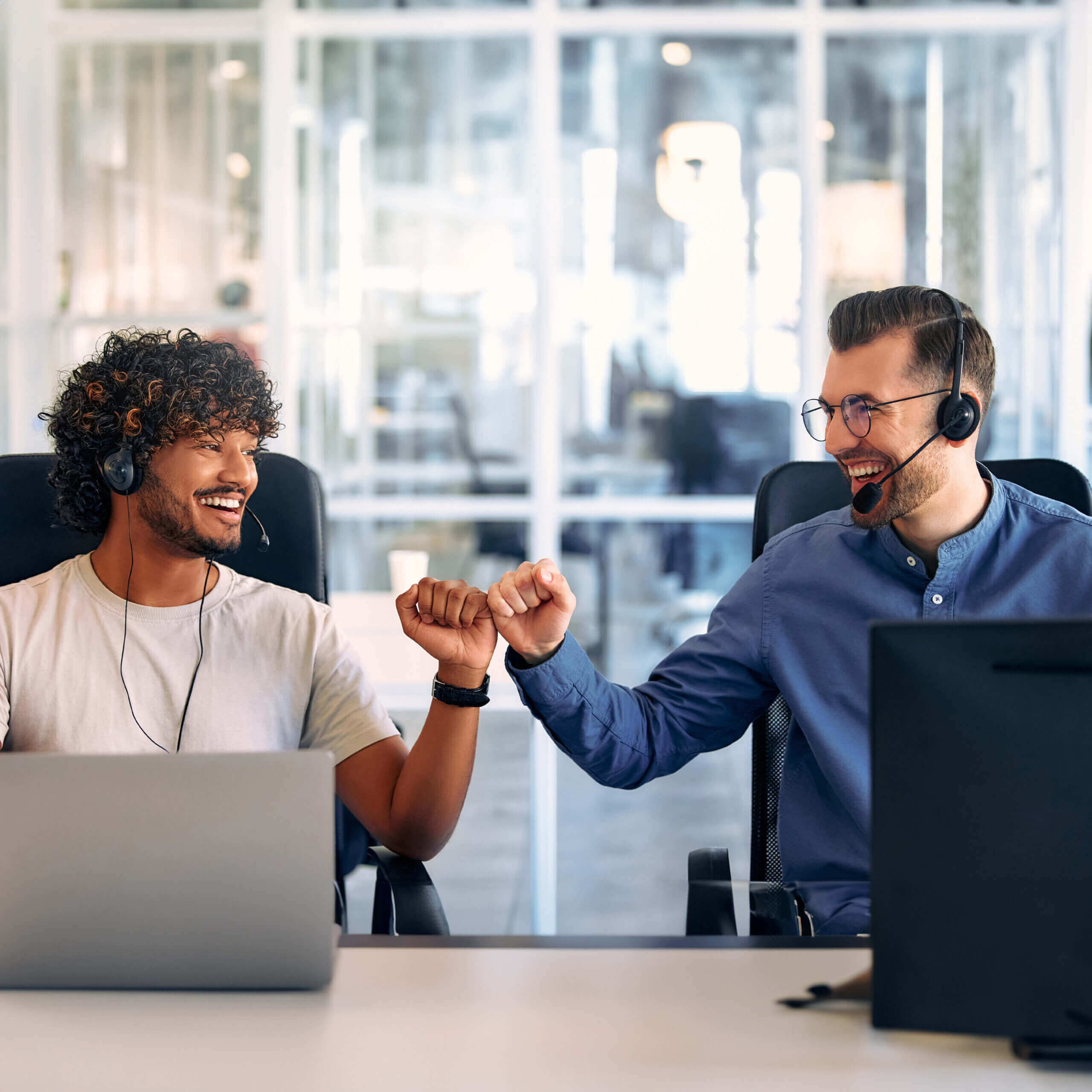 Two call center agents fist bumping